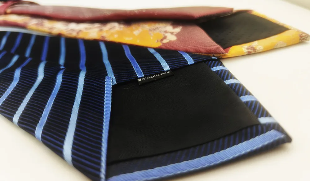  A cross - section view of a tie showing the lining, with a note indicating the appropriate thickness.
